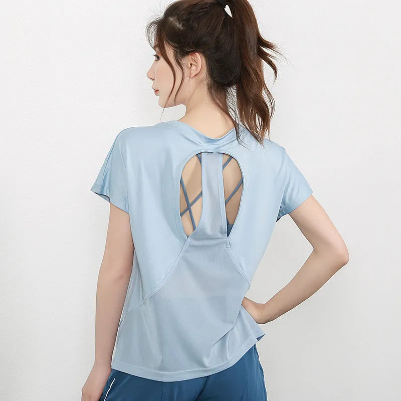 Women's short sleeve polyester sports t-shirt in sky blue, shown on a model.