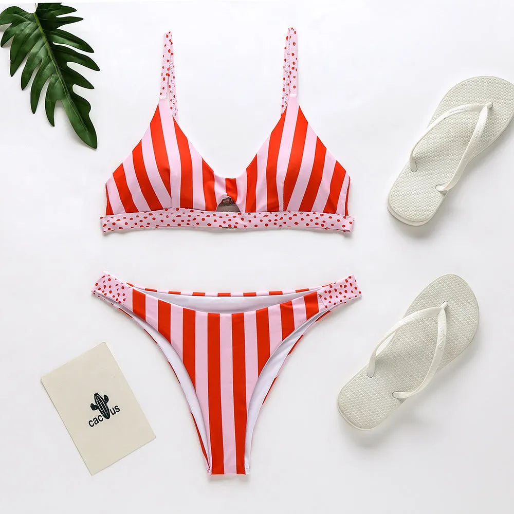 Women's black and white dot polyester bikini set laid flat, showing Asian sizes S, M, L, XL.
