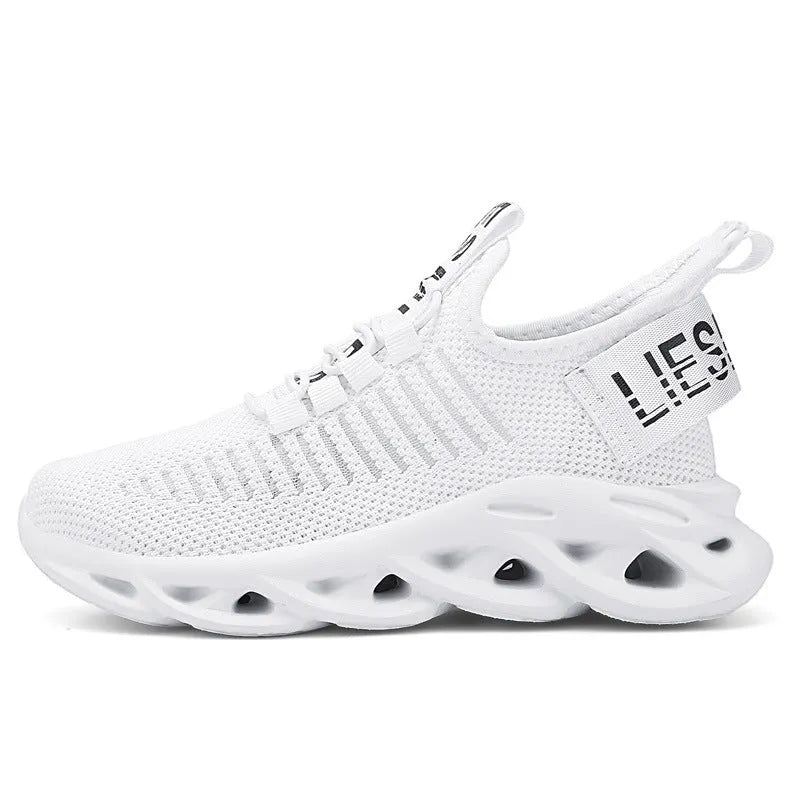 Children's Velcro sneakers in black, khaki, or white with fabric upper and textured sole.
