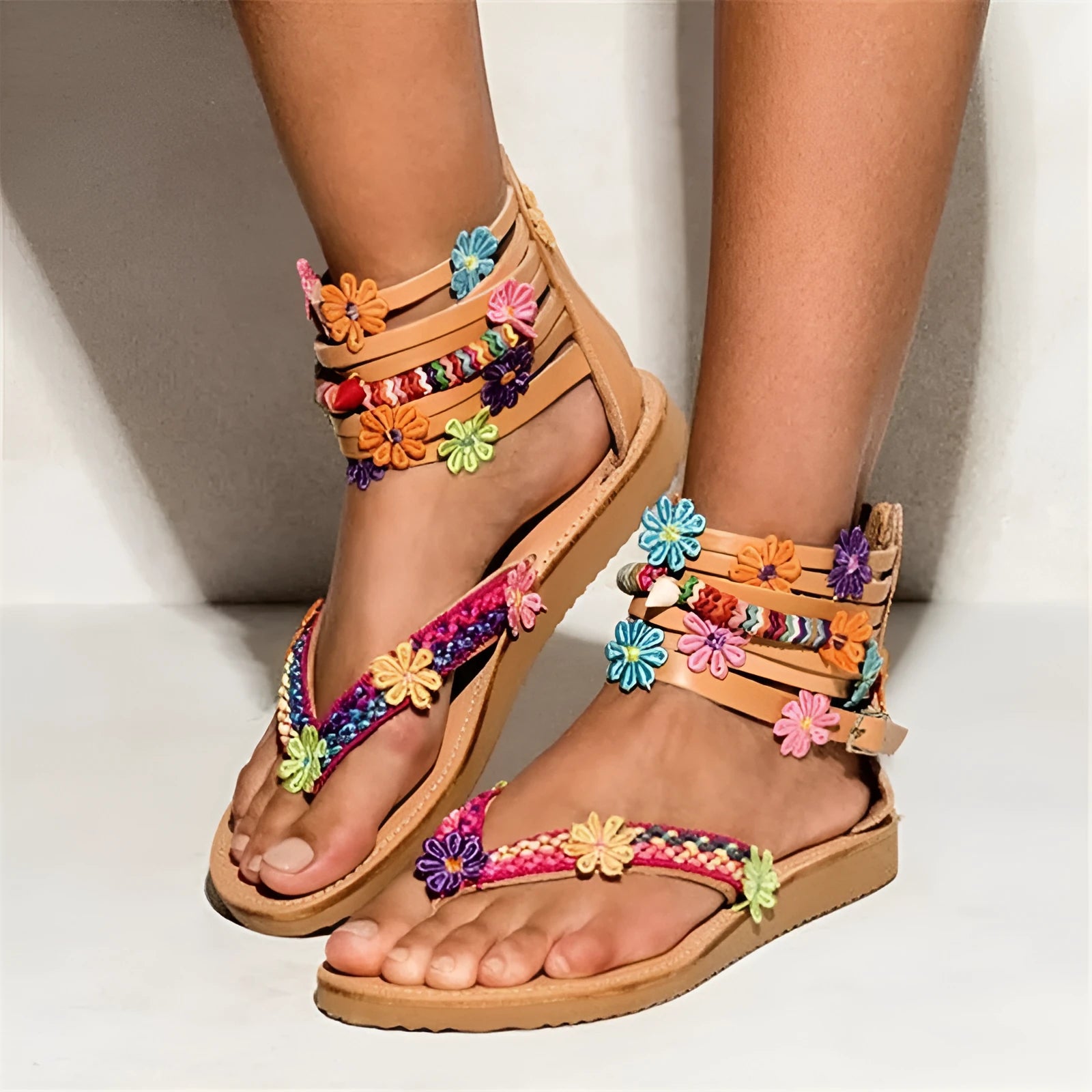 Women's ethnic beaded petal Roman sandals with round toe on a light background.