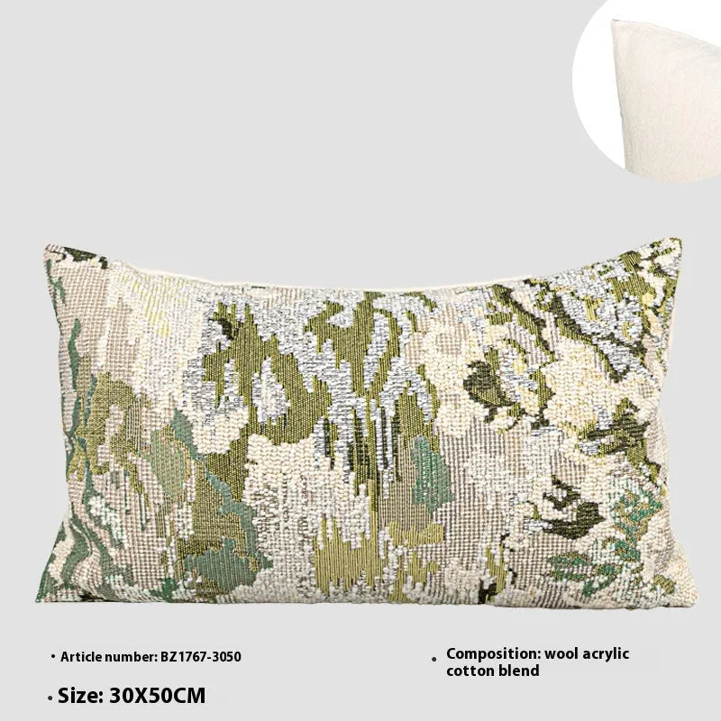 Antique green wool blend decorative pillow with abstract floral pattern, shown in lumbar and square sizes.