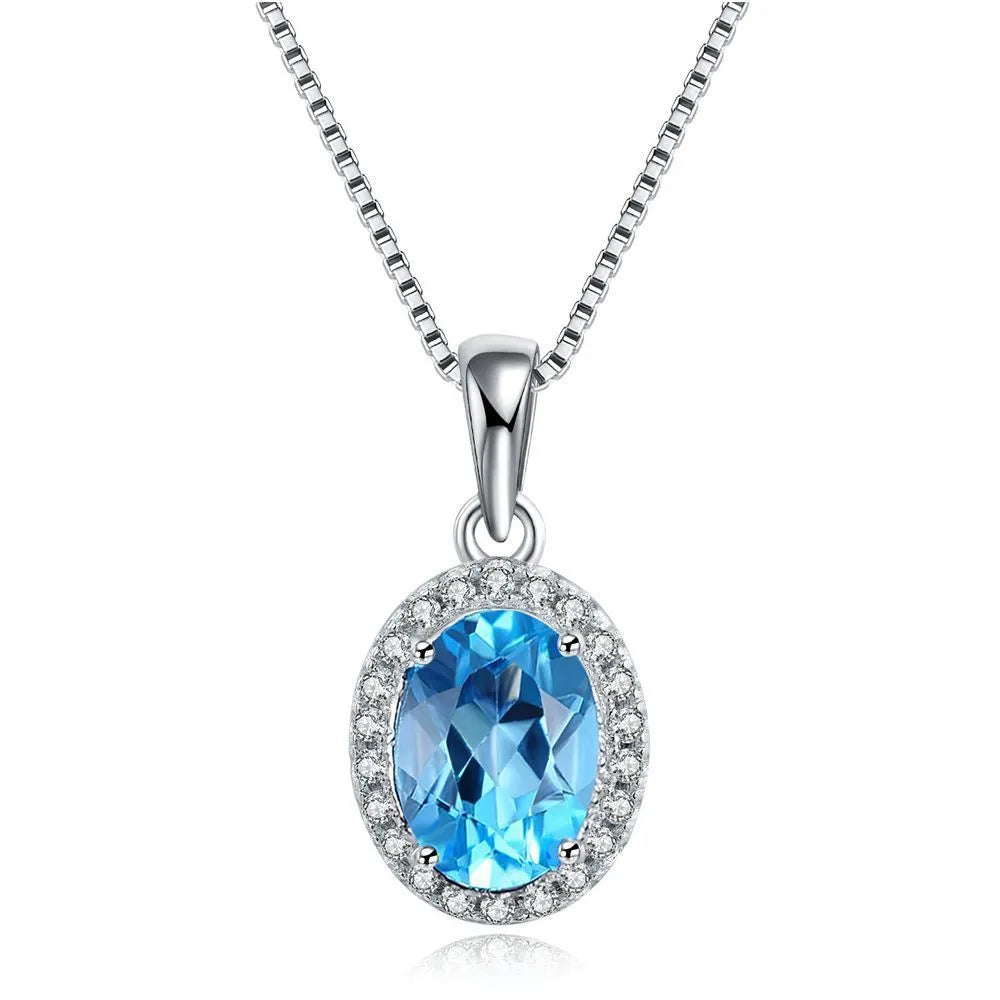 925 sterling silver jewellery set with blue topaz gems showing earrings, ring, pendant and necklace with geometric design