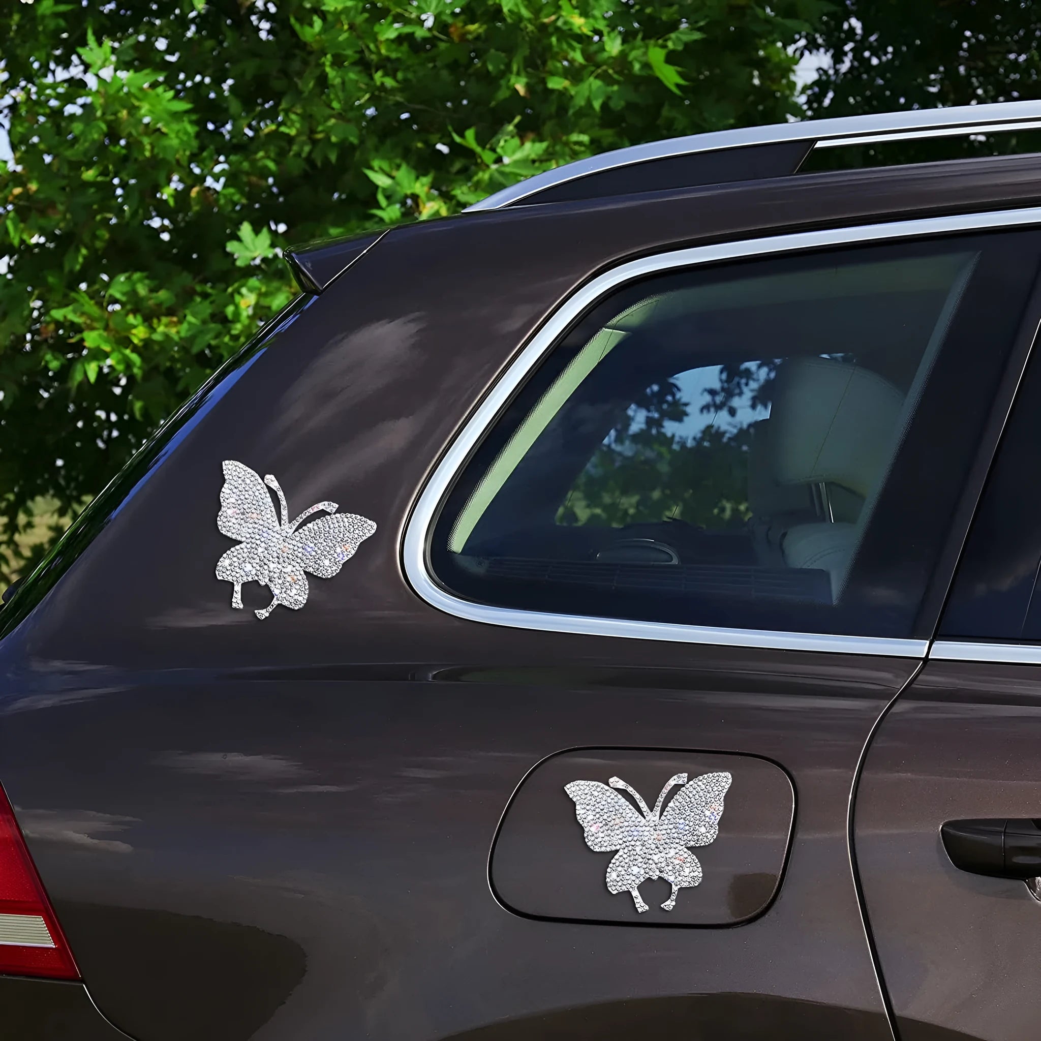 Diamond-encrusted bear paw and butterfly car sticker on vehicle surface