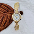 Stainless steel women's watch with round dial on wrist showing gold surface colour