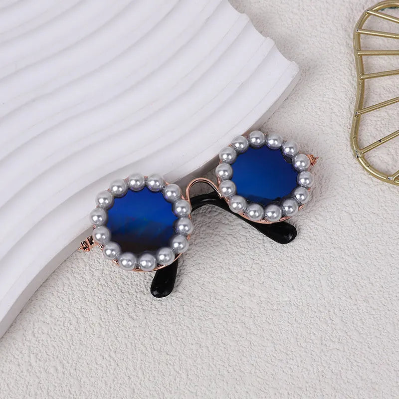 Pearl-rimmed round sunglasses on a cat and dog for costume dress up