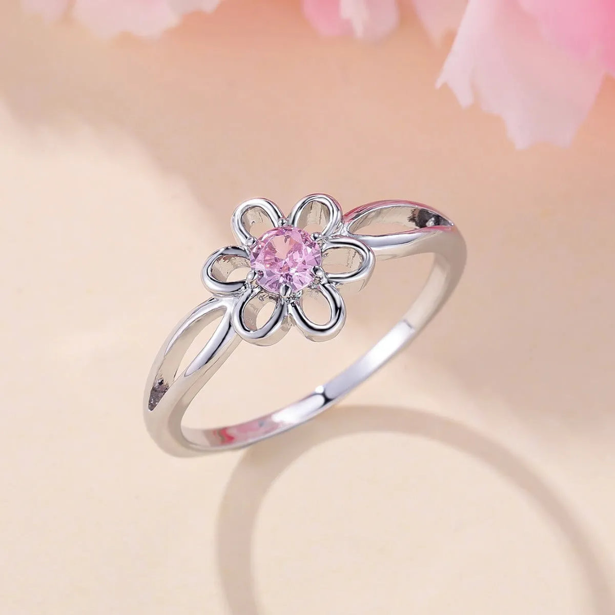 Women's floral hollowed fashion ring in electroplated finish showing flower design detail