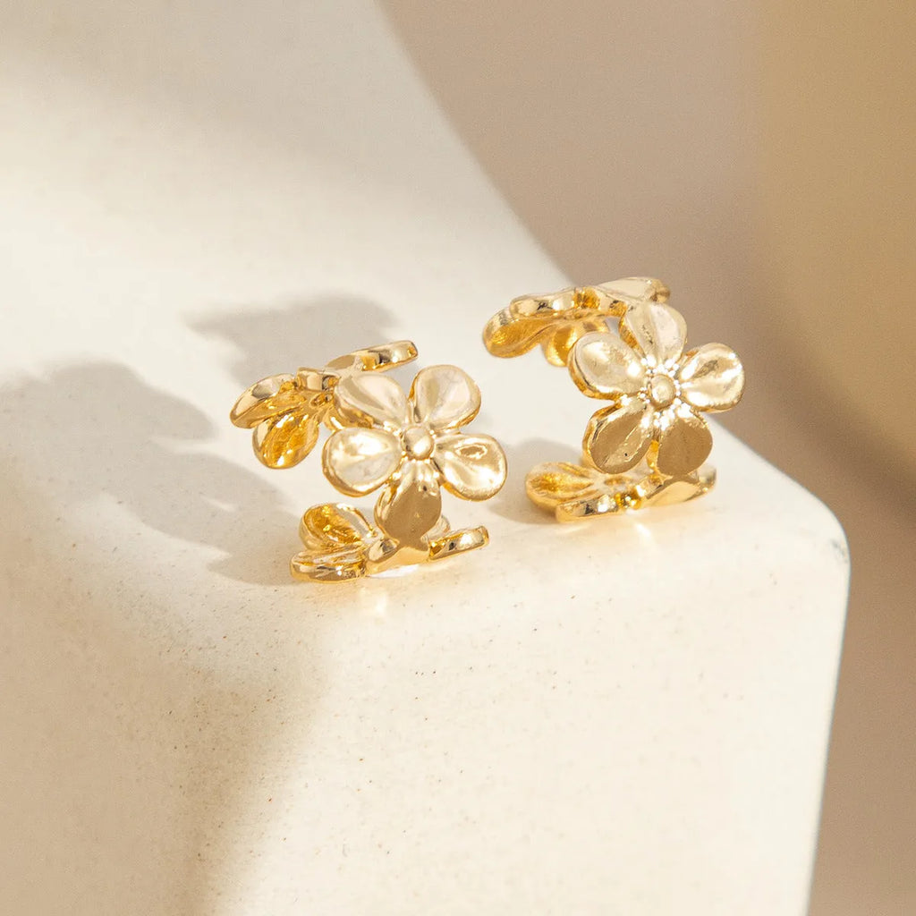 Gold tone women's earrings with starfish and conch shell design