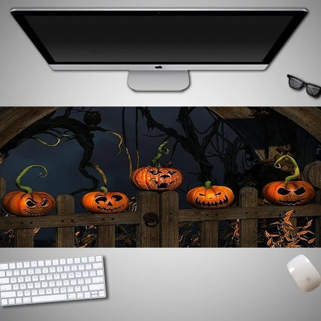 Oversized Halloween-themed rubber cloth mouse pad with non-slip base on a desk.