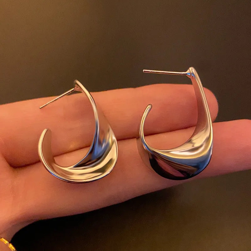 Pair of twisted geometric design metal earrings in gold or silver electroplated finish