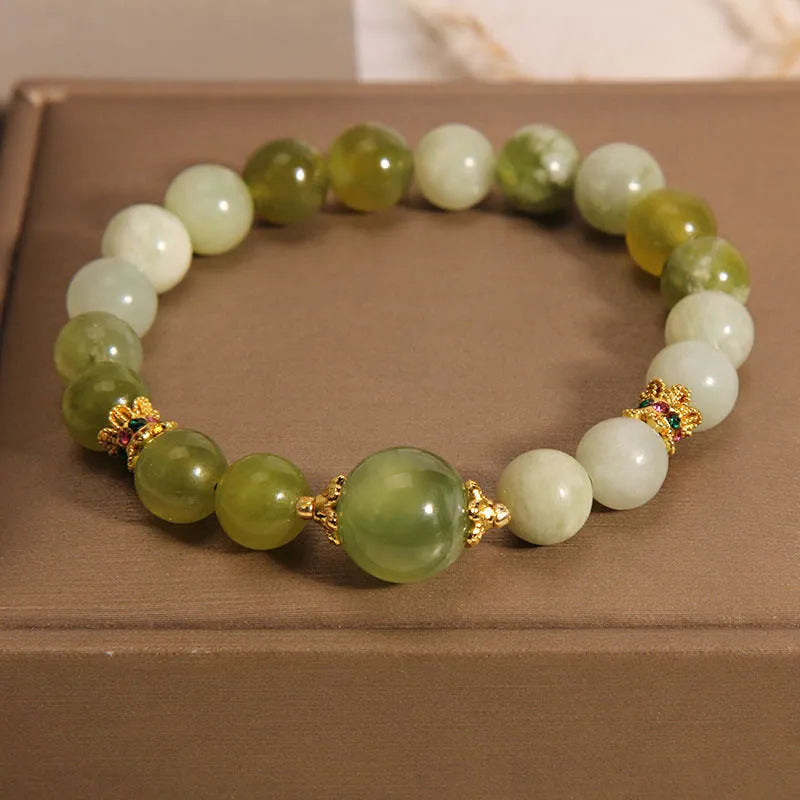 Women's bracelet made of natural green Xiuyan jade in a sweet Mori style.