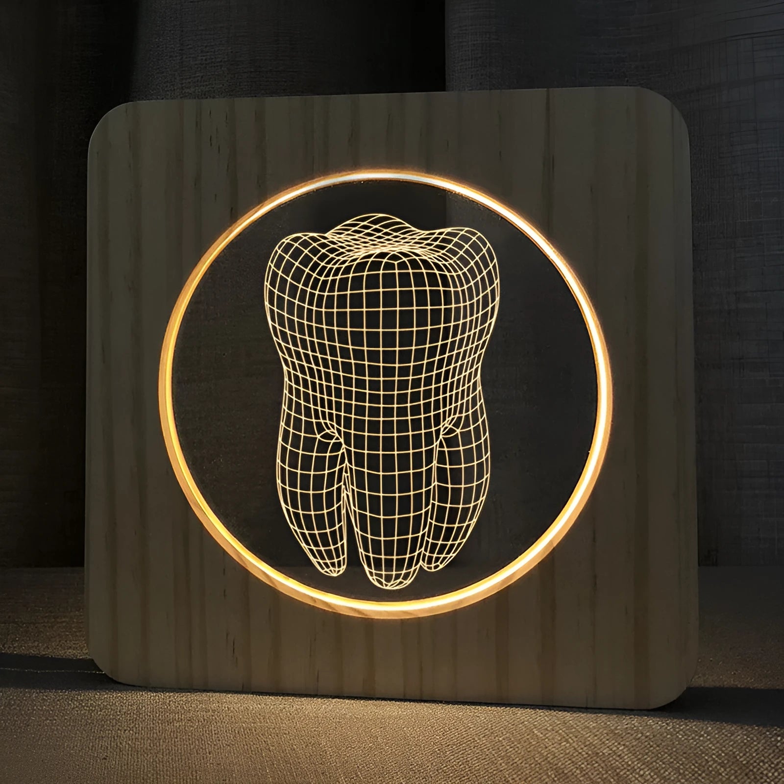 Tooth-shaped wood colour acrylic table lamp with USB cable on a wooden surface.