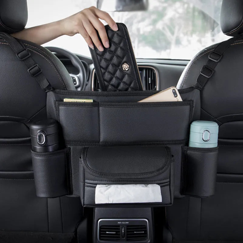 Black leather car seat storage organiser with tissue box between car front seats