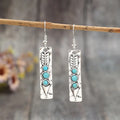 Silver-coloured geometric earrings with turquoise inlay measuring 20-24cm long