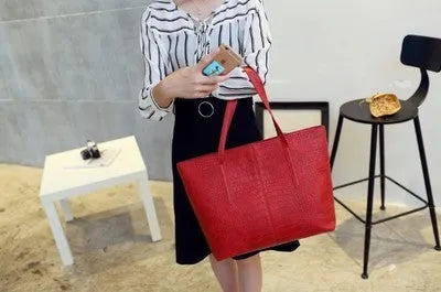 Simple fashion shoulder bag with adjustable strap shown in black and grey colour options