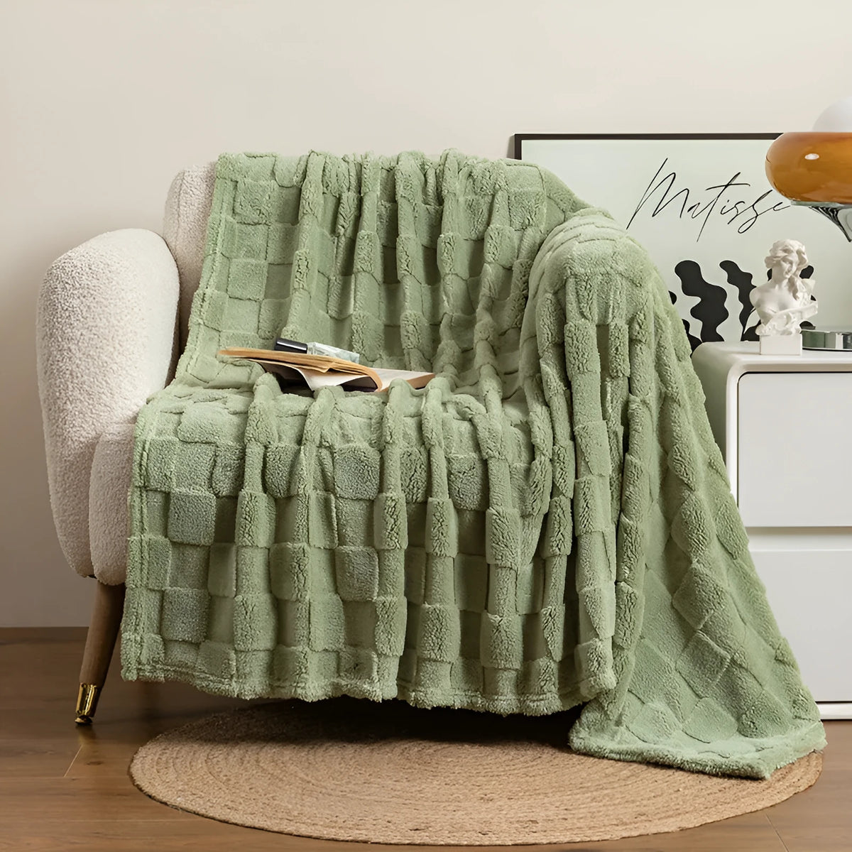 Thickened geometric pattern blanket in a neutral colour, draped over a modern sofa.