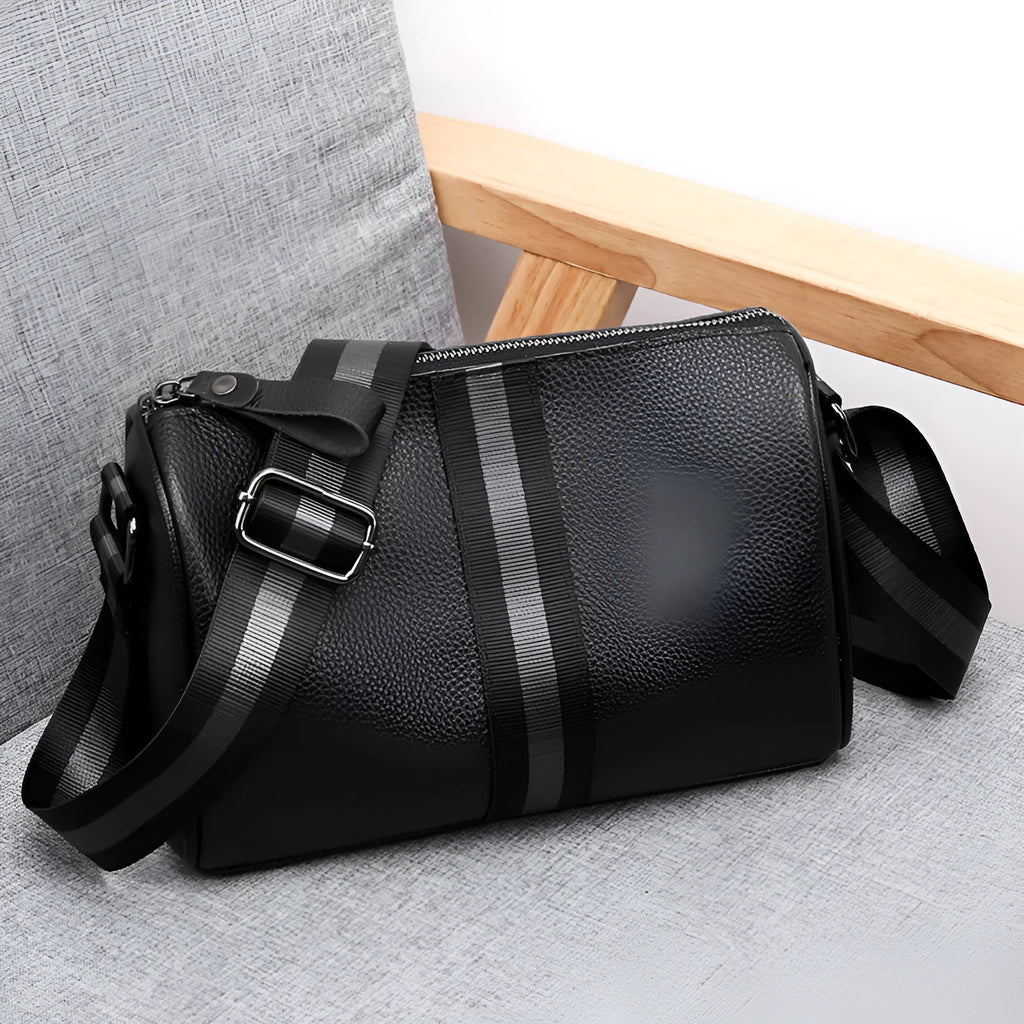 Black genuine leather one-shoulder crossbody bag showing its large size and polyester lining.