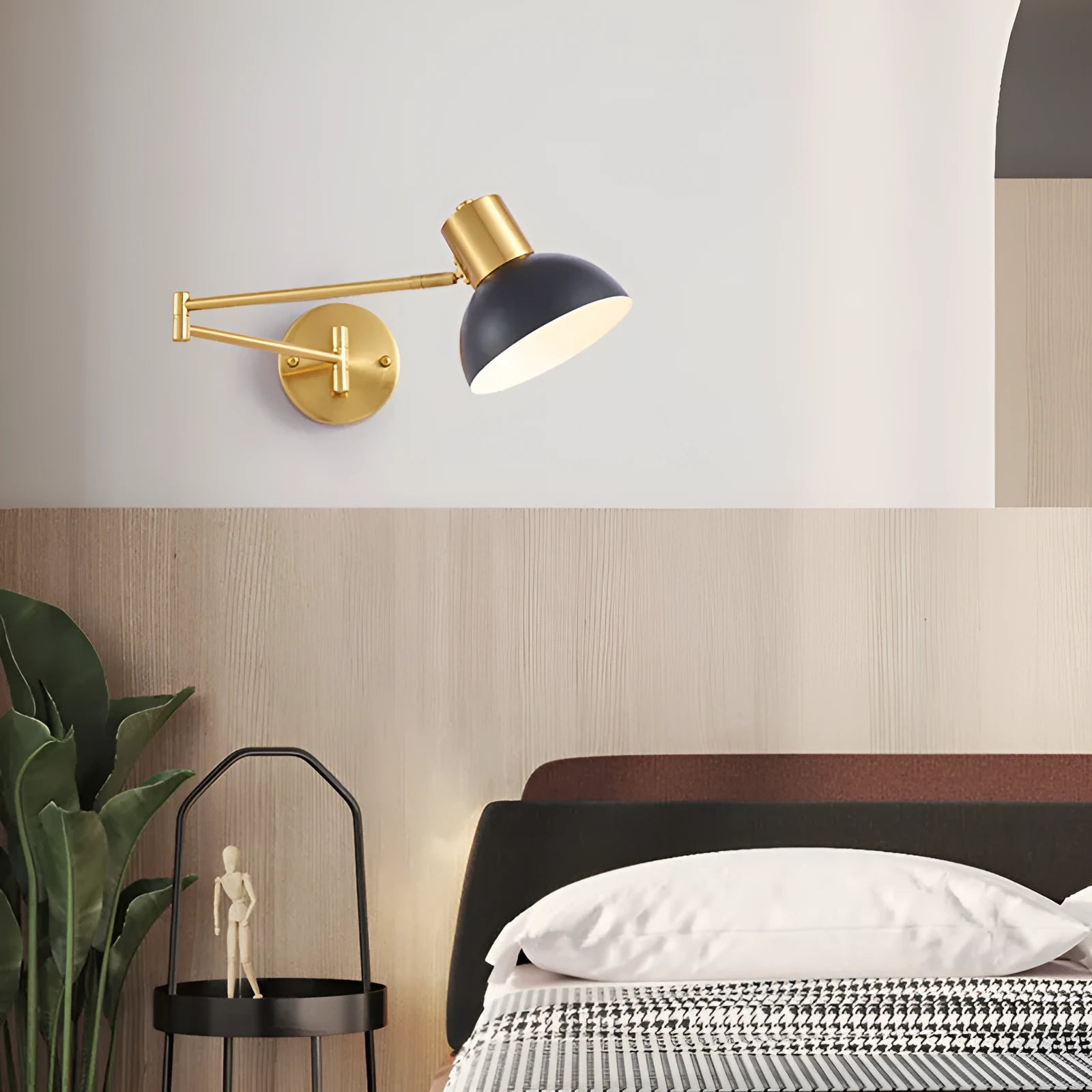 Modern minimalist double-section articulated arm wall lamp mounted on a bedroom wall.