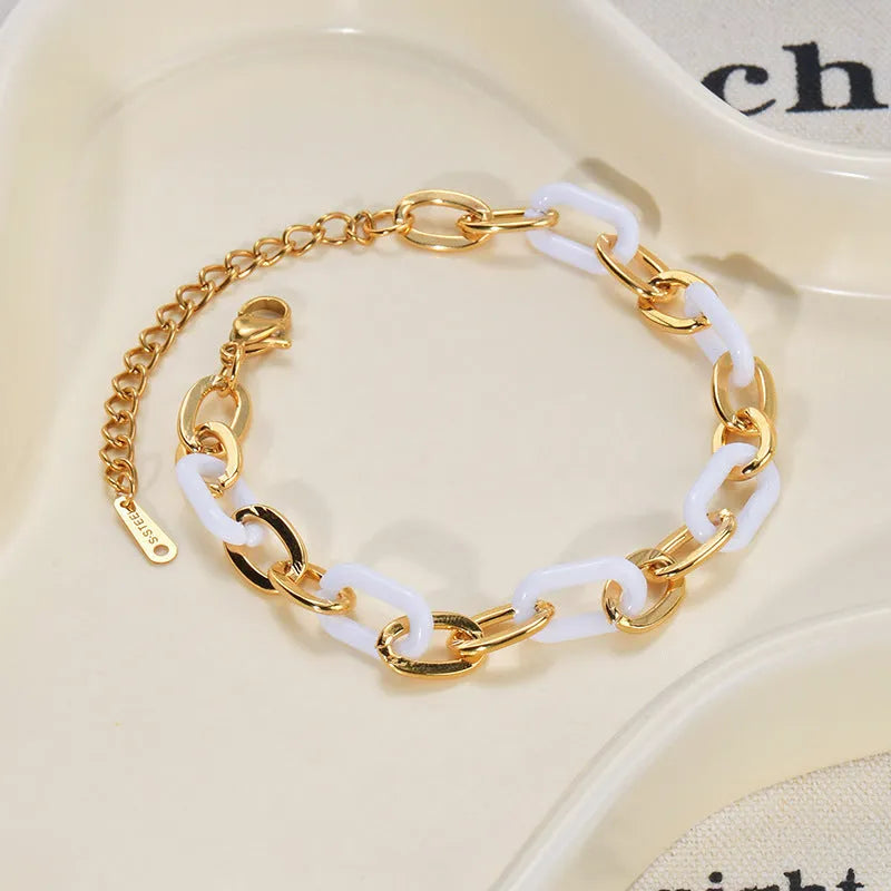 Women's stainless steel bracelet with a double-layered red heart resin charm.