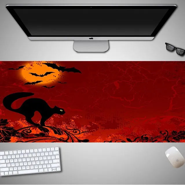 Oversized Halloween-themed rubber cloth mouse pad with non-slip base on a desk.