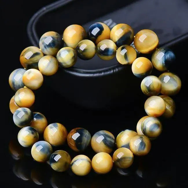 Handmade fantasy tigereye agate bracelet with round beads in a single circle, shown in natural stone colours.