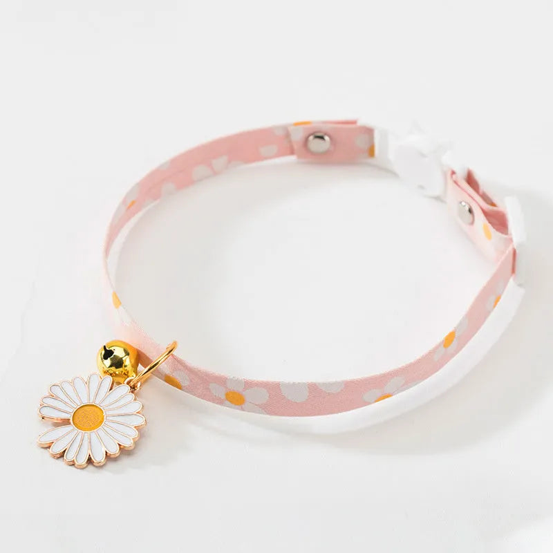 Green adjustable cat collar with a silver bell and a matching bow tie on a white background