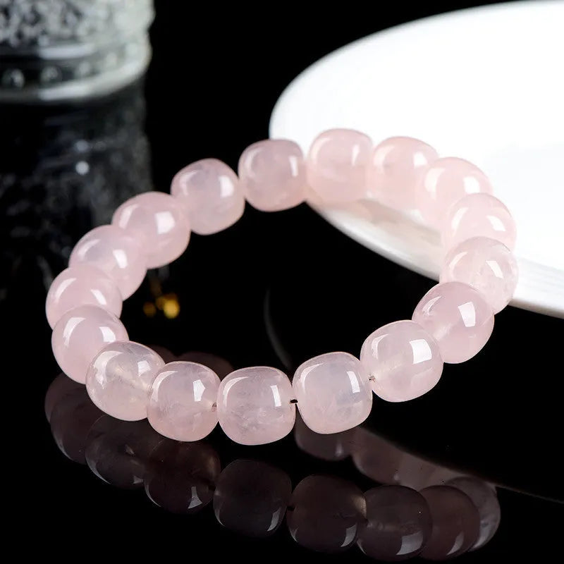 Pink crystal barrel bead bracelet with bamboo accents and geometric design