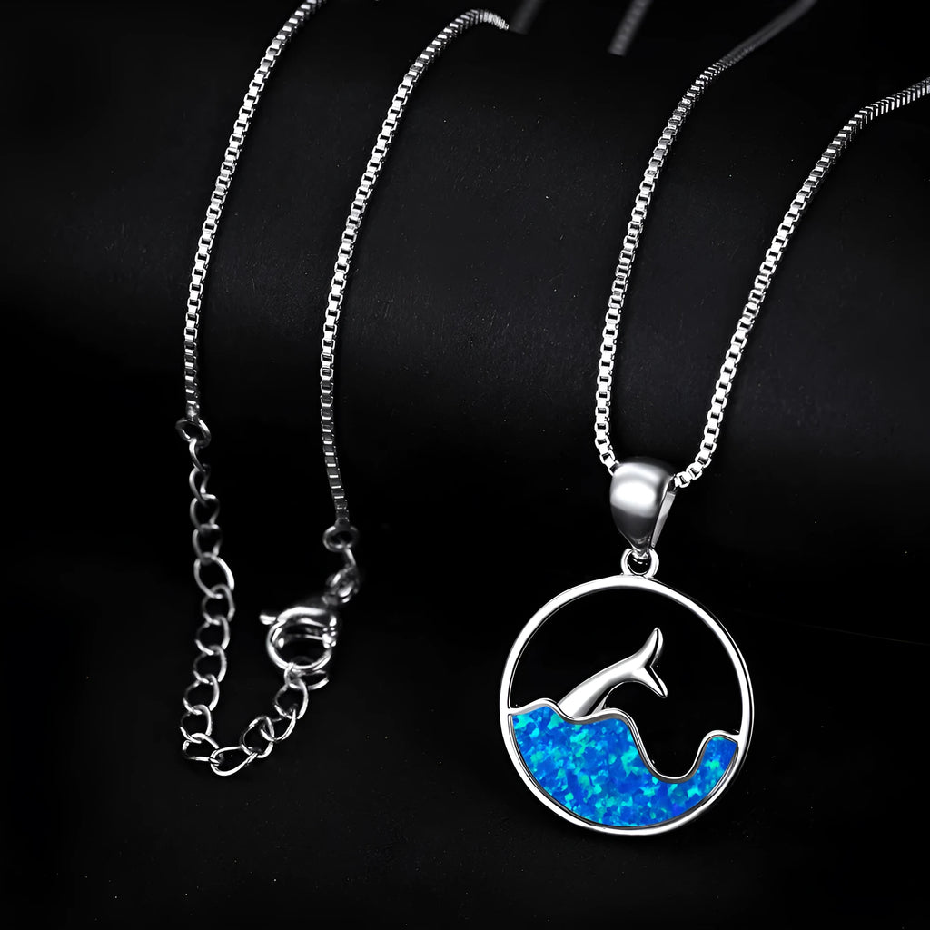 Geometric white gold fishtail necklace with round blue opal centre on model