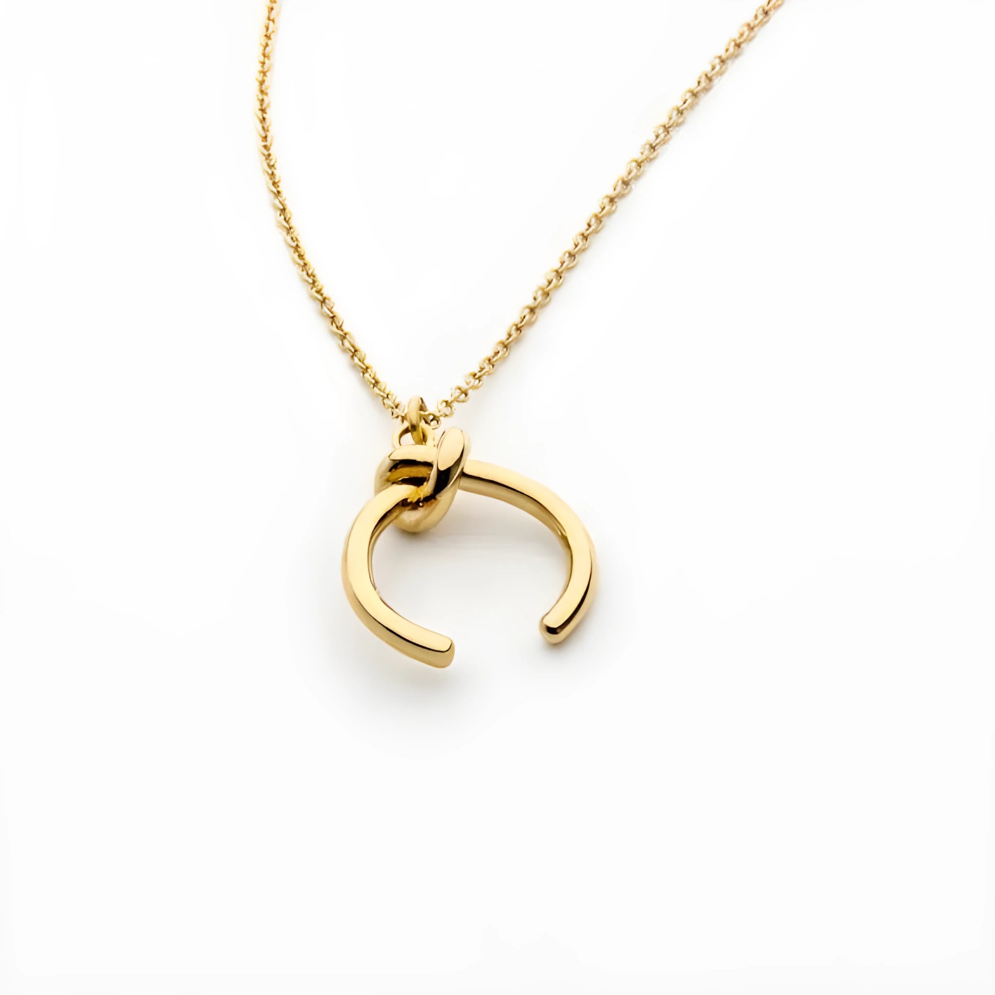 Geometric copper pendant necklace on an adjustable cross chain in gold or silver finish.