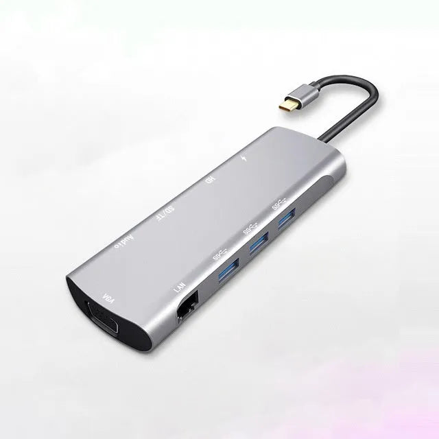 Grey aluminium USB-C docking station with HDMI, VGA, USB ports, and a short connecting cable