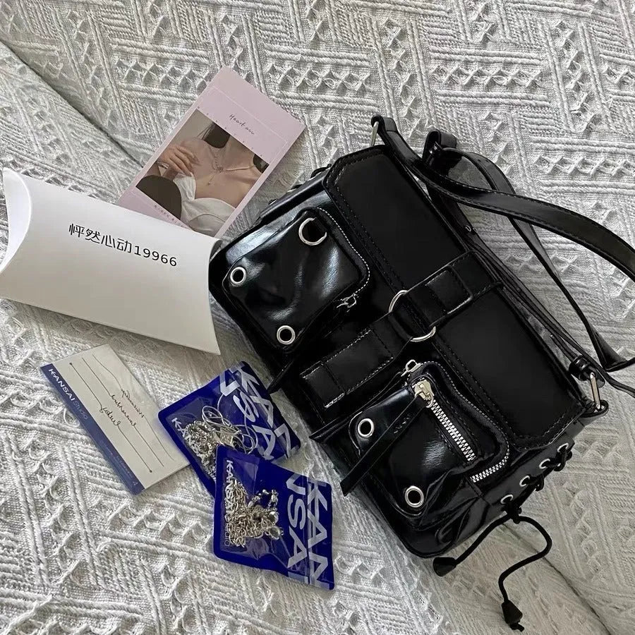 Black structured PU baguette messenger bag with a long adjustable shoulder strap.