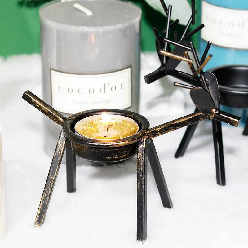 Black iron elk Christmas candlestick holder on table with candle