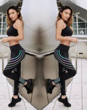 Women's black and white workout leggings with night glowing print, showing slim fit pencil pants style.