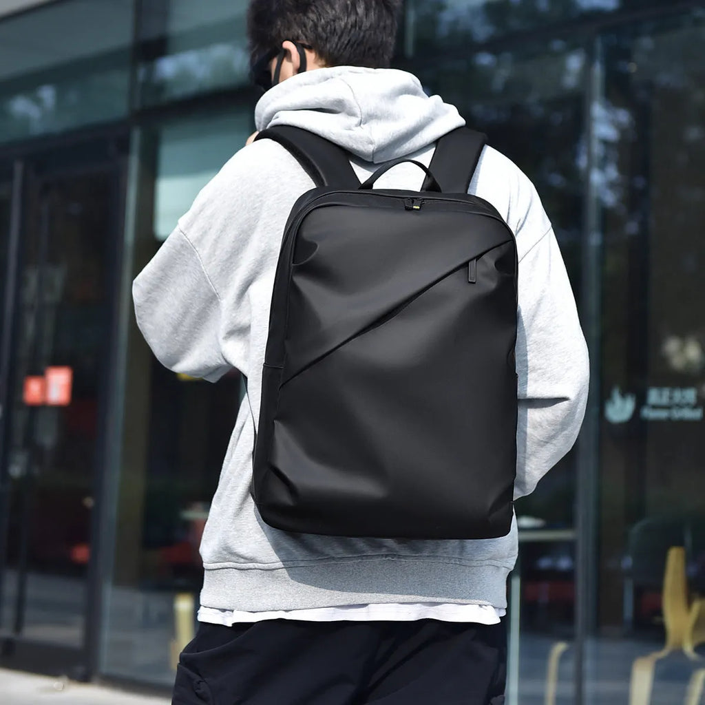 Waterproof large capacity black PU backpack with sewing thread detailing, shown closed.