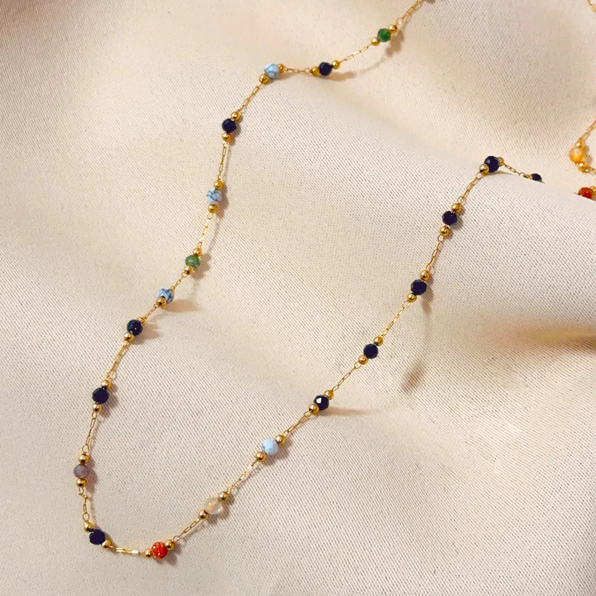 Gold electroplated titanium steel necklace with a natural stone pendant on an O-ring chain.