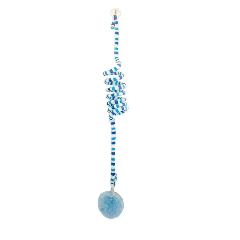 Colourful suction cup cat toy with spring wand and inflatable ball, hanging on a glass door