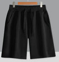 Man wearing straight-cut light grey cotton summer shorts, showcasing the fifth pants length and casual fit.