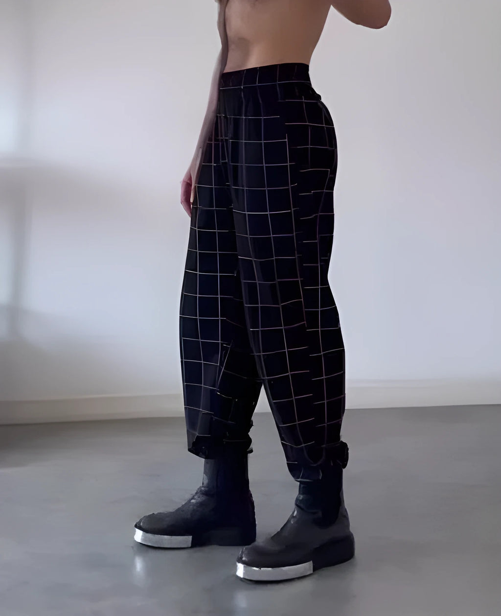 Men's plaid trousers with apron waist design showing front overlap detail