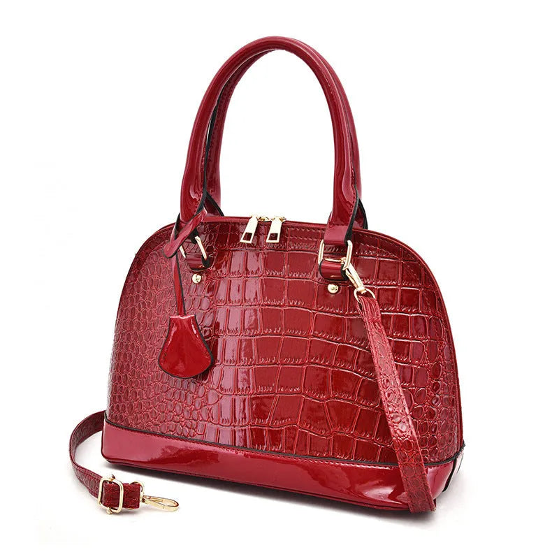 Large shiny PU leather crossbody bag in shell shape design on adjustable strap
