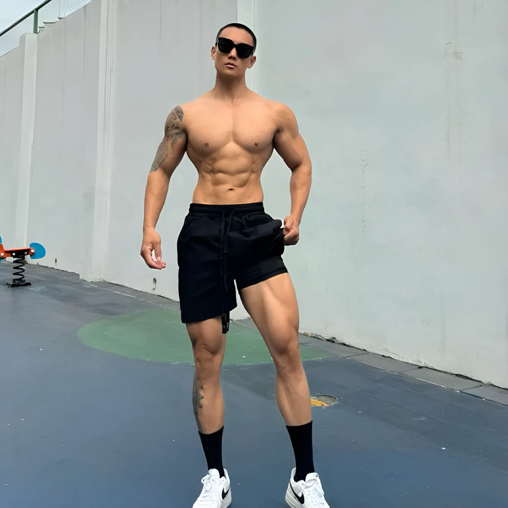 Men's ice silk quick-drying double-layer shorts in black, showing layered construction and casual fit