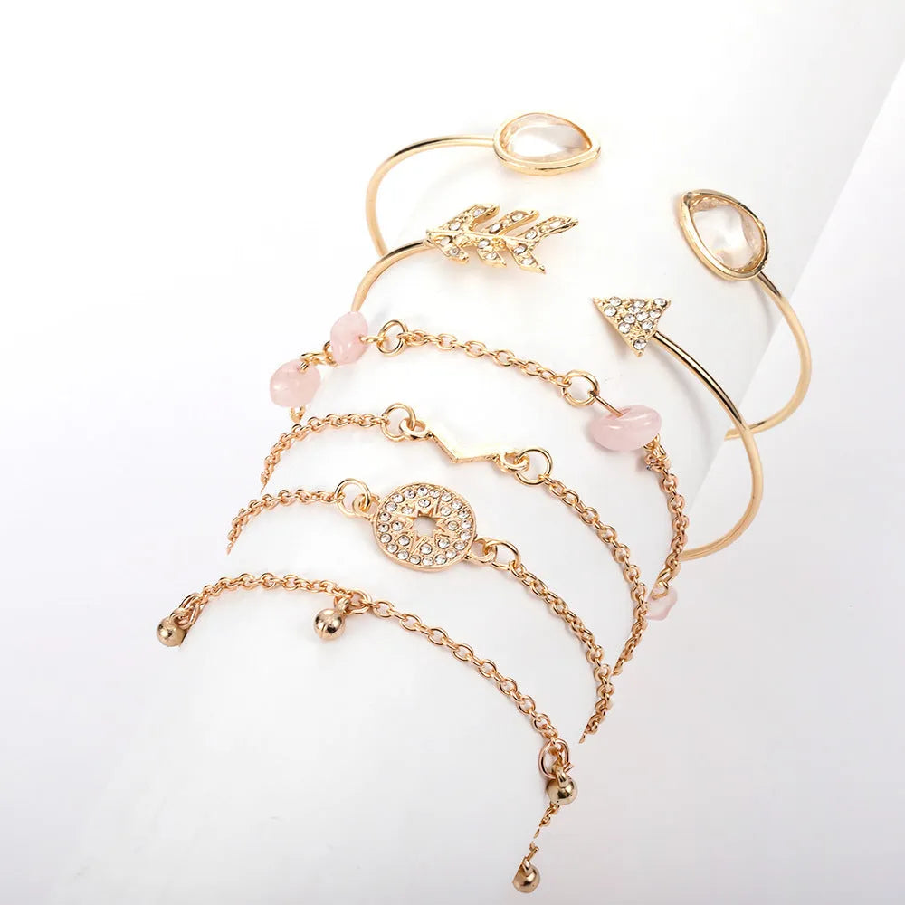 Gold zinc alloy bracelet set with six charms including spot drill, arrow, and water drop shapes.