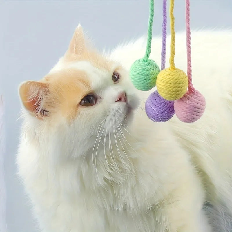 Colourful cat toy ball with rope attachment and internal bell for interactive kitten play