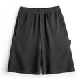 Cement grey polyester sports shorts with straight cut design and elastic waistband