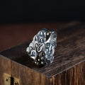Silver open style ring with a detailed jibeast animal zodiac pattern.