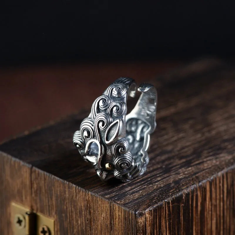 Silver open style ring with a detailed jibeast animal zodiac pattern.