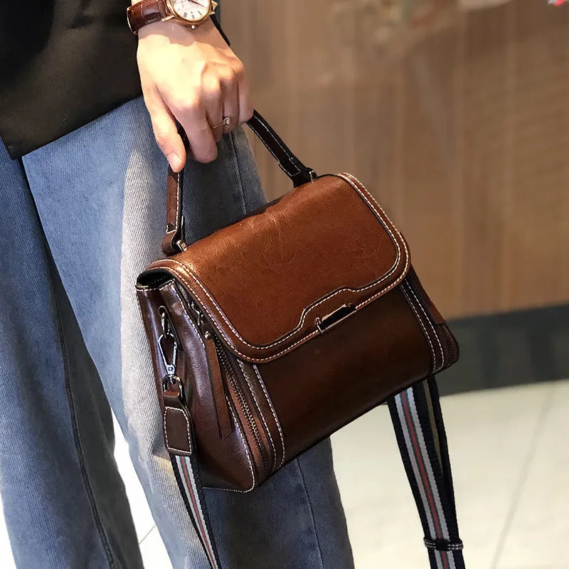 Women's genuine leather messenger bag in retro styling with multiple internal compartments