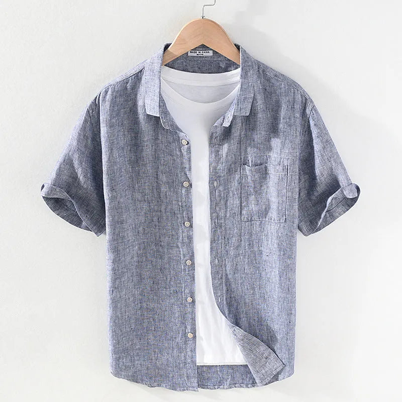 Men's light brown linen shirt with a square collar and short sleeves, shown on a hanger.