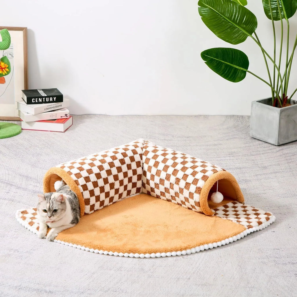 Fan-shaped plaid pet bed with integrated tunnel for dogs and cats in coffee colour, showing soft plush fabric.