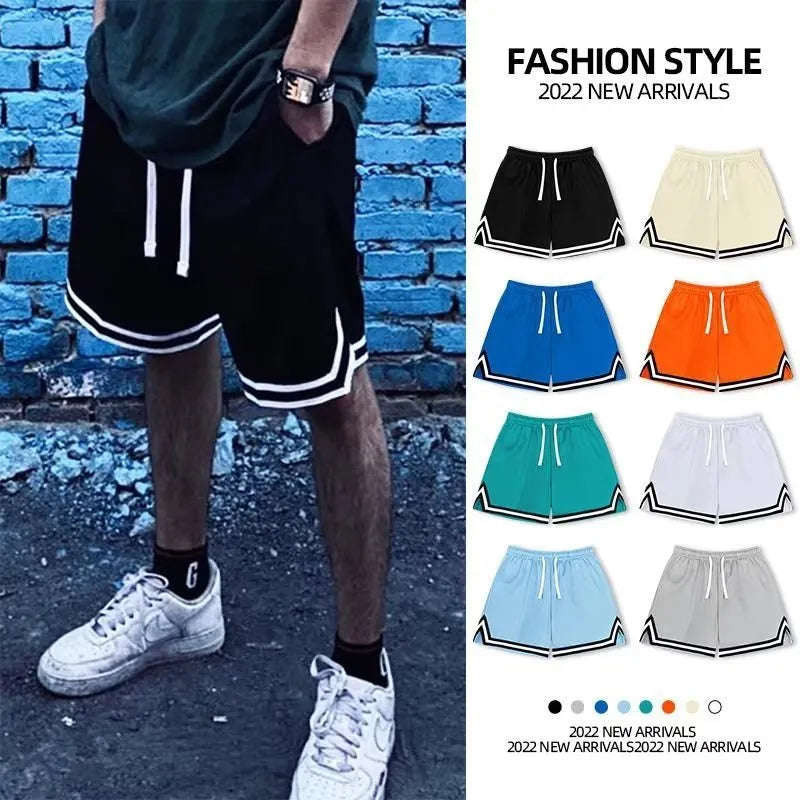 Man wearing loose grey sports shorts made from polyester fabric, showcasing the fit and style.