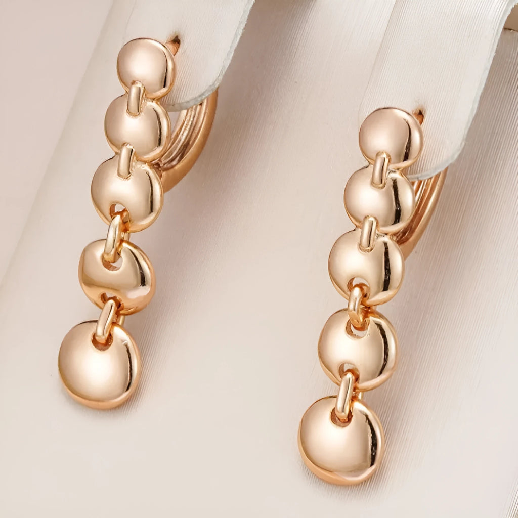 Retro long round copper earrings with woven design in a gold colour finish.