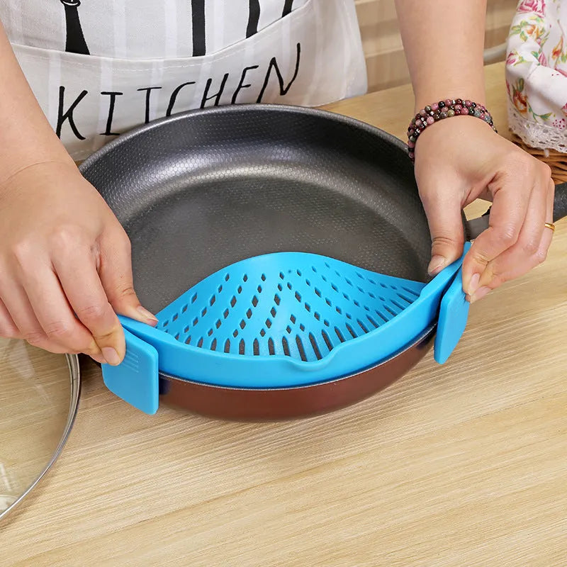 Silicone clip-on funnel colander in kitchen draining liquid from pot